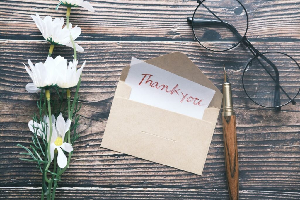 Handwritten thank you note on a table, for a teacher or carer gift